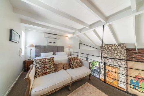 a bedroom with a bed and a couch at The Yard in Franschhoek