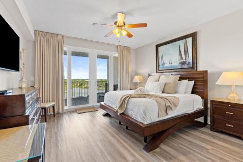 a bedroom with a bed and a large window at Laketown Wharf 933 in Panama City Beach