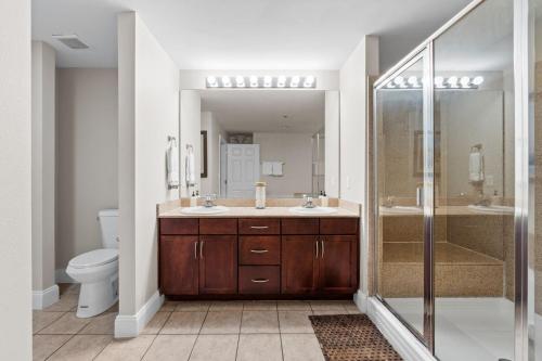 a bathroom with a toilet and a sink and a shower at Laketown Wharf 933 in Panama City Beach