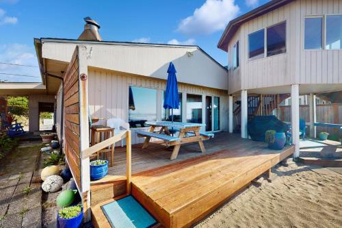 a house on the beach with a wooden deck at 2 Bed 2 Bath Vacation home in Rockaway Beach in Rockaway Beach