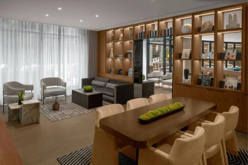 a living room with a table and chairs and a couch at AC Hotel Arlington National Landing in Arlington