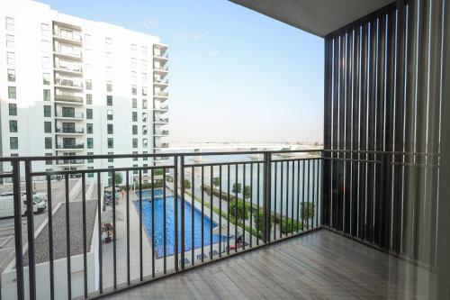 a balcony with a view of a pool and buildings at Seabreeze Studio Yas Island in Abu Dhabi