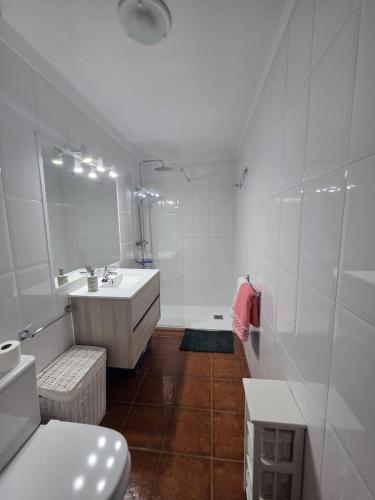 a bathroom with a tub and a sink and a toilet at Miel de Guarapo Apartment in La Gomera