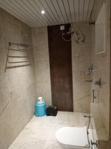 a bathroom with a shower and a toilet and a sink at Hotel Relax in Jāmb
