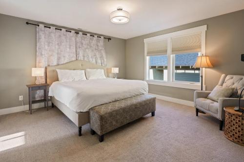 a bedroom with a bed and a chair and a window at Hillside Haven in Bend