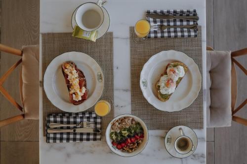 a table with plates of food and a cup of coffee at Hotel Palacio de Caranceja in Reocín