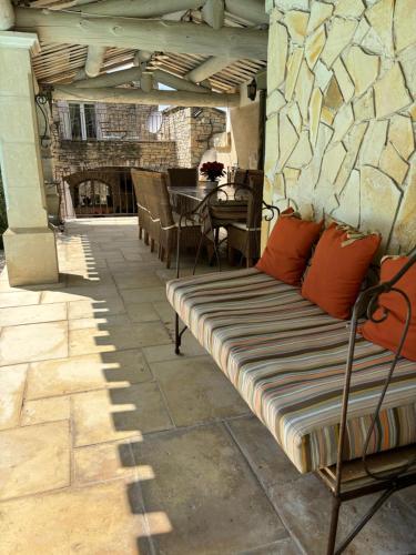 a patio with a couch and a table and a tableablish at La Pasclapierre in Orgon