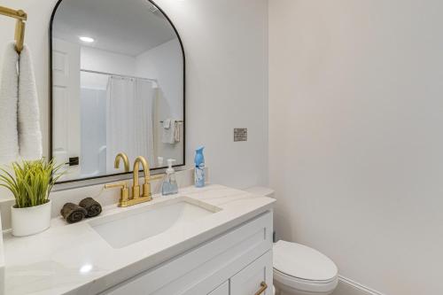 a white bathroom with a sink and a mirror at Private Boat Slip, Scenic Views Norris Lake Condo in Alder