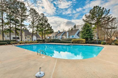 a large swimming pool in a yard with houses at Chic Charlotte Townhome with Community Pool in Charlotte