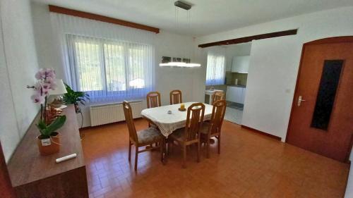 a kitchen and dining room with a table and chairs at Casa Camelia in Intragna
