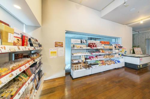 a grocery store aisle with a door open with food at Yokohama Techno Tower Hotel in Yokohama