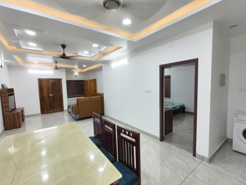 a living room with a table and a mirror at White Shadow in Varkala