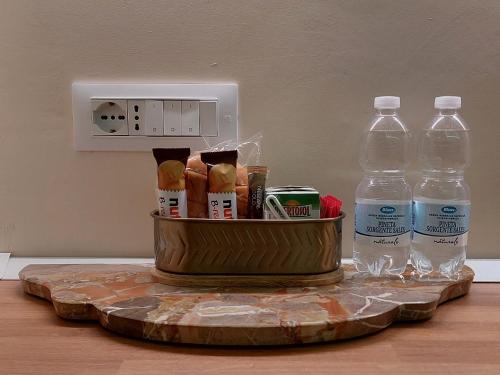 a clock and two bottles of water on a table at Brindisina Apartment in Turin