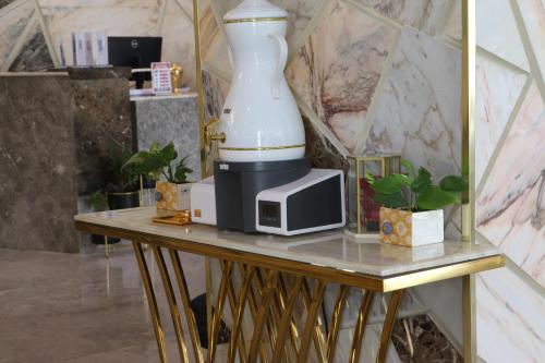 a table with a blender and a microwave on it at Best Western Premier in Riyadh