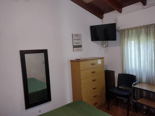 a bedroom with a dresser and a mirror and a desk at DEPARTAMENTO EN LOMA HERMOSA 2 in Loma Hermosa