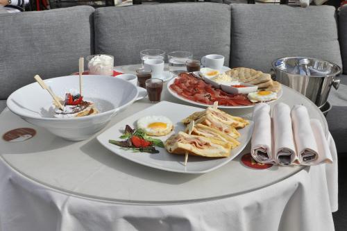 a table with three plates of food on it at Luna Stay in Trieste