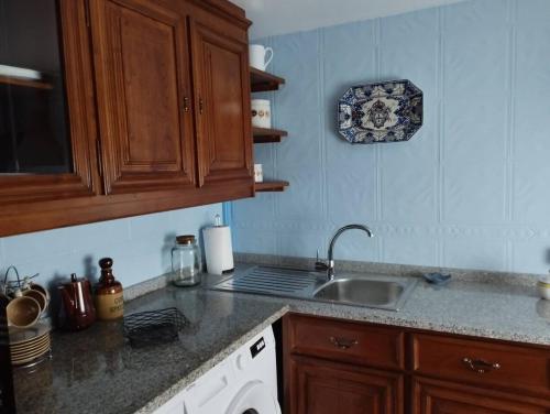 a kitchen with a sink and a counter top at 3HOUSE Sol na Eira in Rebordosa