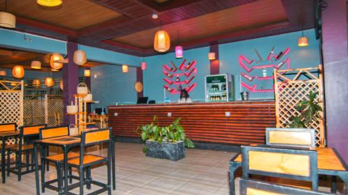 a restaurant with tables and chairs and a bar at montana restaurant musanze in Ruhengeri