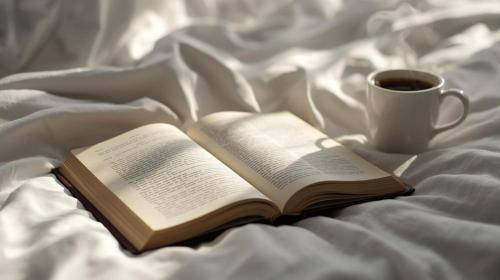an open book on a bed with a cup of coffee at Bella Canosa casa vacanza con 3 camere da letto e posto auto custodito in Canosa di Puglia