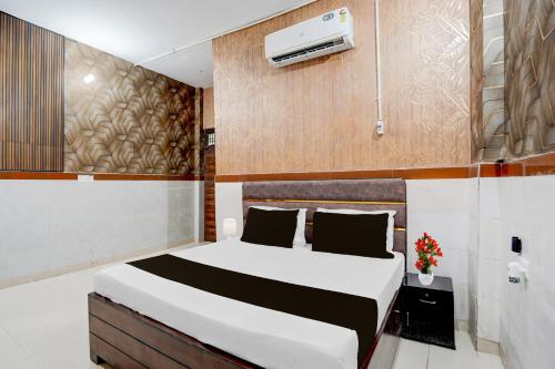 a bedroom with a bed and a air conditioner at Hotel O Brij Ghat Mukteshwar Formerly Brijwasi Guest House in Kankather