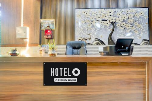 a hotel reception desk with a sign on it at Hotel O Brij Ghat Mukteshwar Formerly Brijwasi Guest House in Kankather