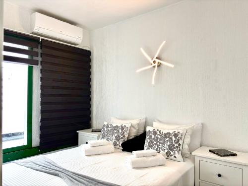 a bedroom with a bed with a clock on the wall at Onyx apartment in Puerto del Carmen