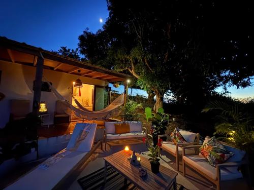 a patio with couches and a table at night at Lady Aura Casitas in Cabo Rojo, Puerto Rico in Cabo Rojo