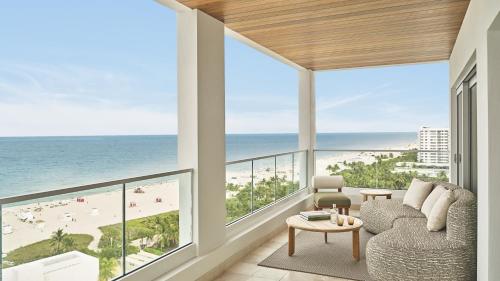 a living room with a view of the beach at The Shelborne by Proper, a Member of Design Hotels in Miami Beach