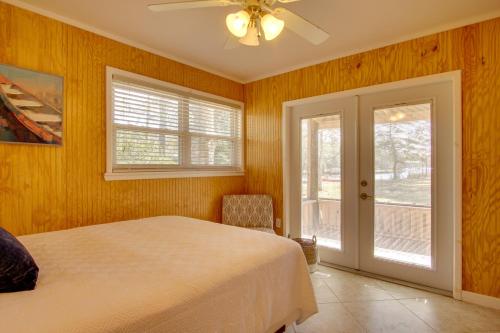 ElbertaにあるWaterfront Foley Area Home - 15 Mi to Gulf!のベッドとガラスの引き戸のある寝室
