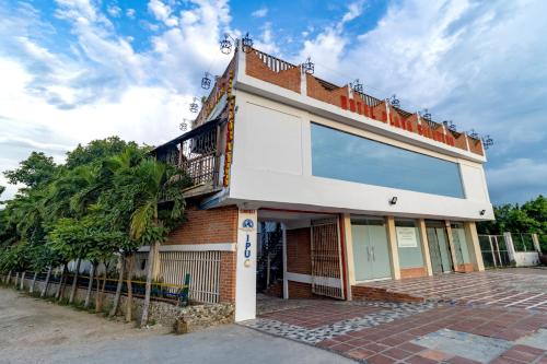 a building with a balcony on the side of it at Hotel Playa Salguero By GEH Suites in Santa Marta