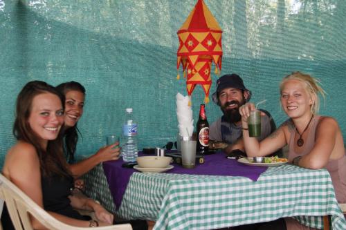 a group of people sitting at a table at Mentokling Guest House and Garden Restaurant in Leh