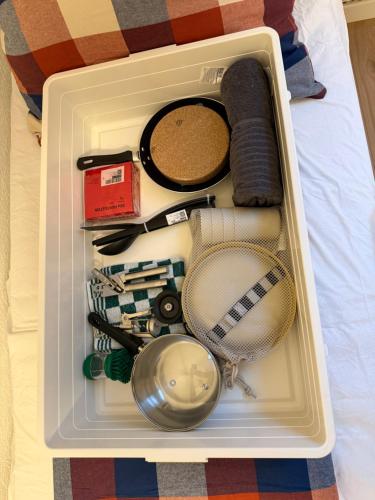 a lunch box with various items in it on a bed at Zimmer direkt an dem Rheinsteig neben der WHU mitten im Zentrum von Vallendar in Vallendar