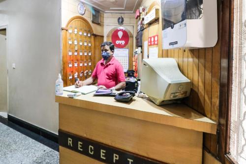 a man wearing a mask at a counter in a store at Hotel O Surya in Ludhiana