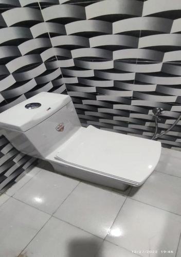 a white laptop sitting on the floor in front of a wall at Shree mahal in Jāmb
