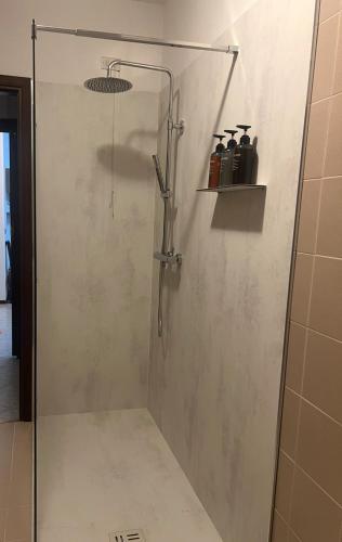 a shower with a glass door in a bathroom at Casa LORY in Brescia