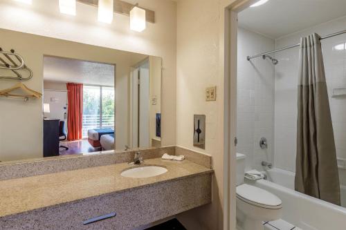 ein Badezimmer mit Waschbecken, Toilette und Spiegel in der Unterkunft Motel 6-Dumfries, VA in Dumfries