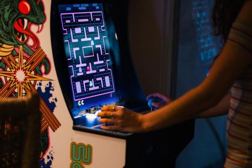 a woman is playing a game on a machine at Saltwater Pool - HotTub - Games - Good Vibes Only! in Indio