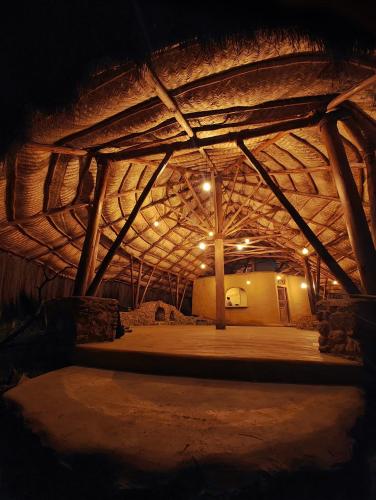 a large building with a wooden ceiling at night at EKa Forest in Vattavada