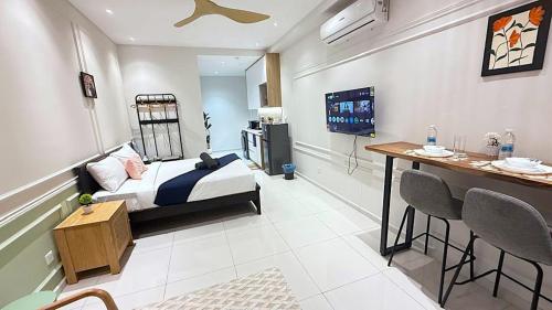 a bedroom with a bed and a bar in it at Majestic Residence Suites KLCC in Kuala Lumpur