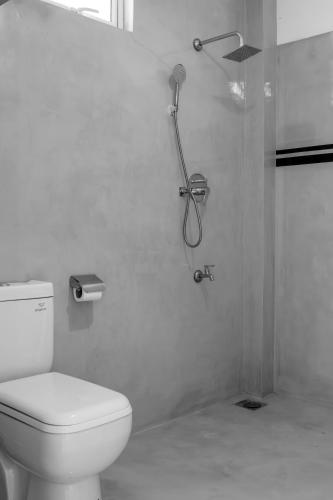 a bathroom with a shower with a toilet and a shower at Sansun Guesthouse in Mirissa