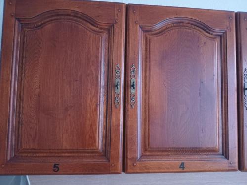 two wooden cabinets sitting on top of a shelf at Hostel Diana in Wermelskirchen