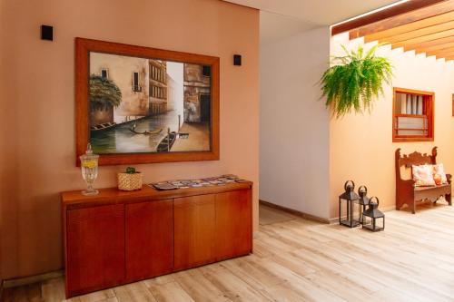 a living room with a painting on the wall at Vila de Cunha in Cunha