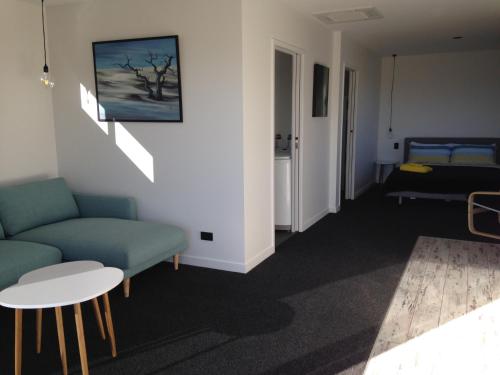 a living room with a couch and a bed at Simply Stunning Studio 1 in Lake Tekapo