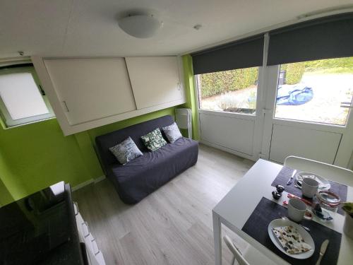 a living room with a couch and a table at L'Echappée verte in Spa