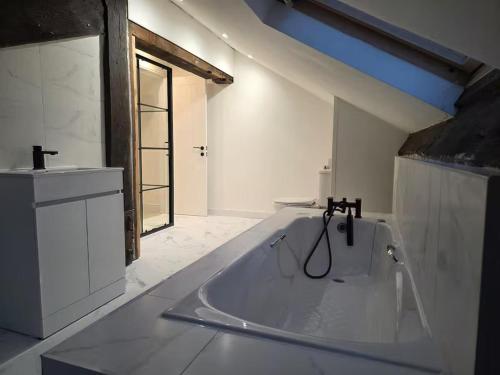 a white bathroom with a tub and a sink at Liverpool Penthouse - Sleeps 8 - City Centre in Liverpool