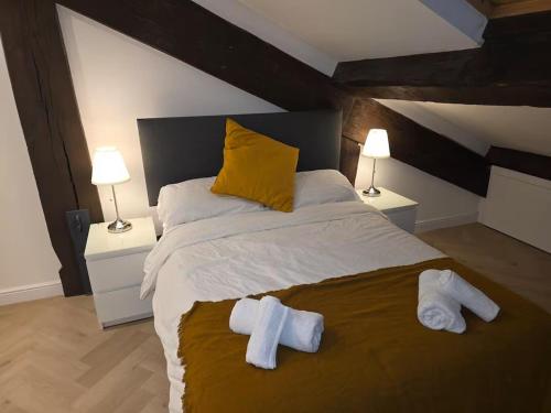 a bedroom with a large bed with towels on it at Liverpool Penthouse - Sleeps 8 - City Centre in Liverpool