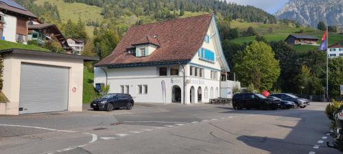 a large white house with cars parked in a parking lot at Fischers Fritz in Innerthal