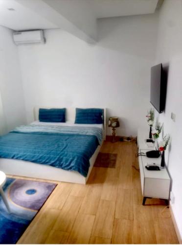 En eller flere senge i et værelse på CNS Guest House