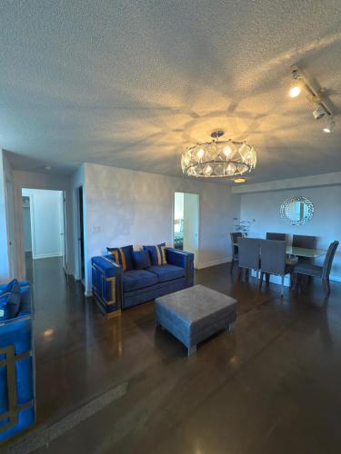 a living room with a blue couch and a table at Toronto Downtown Luxurious Stylish 3 Bedroom 3 Bath 2 Balconies near Rogers Centre lakeview condo in Toronto