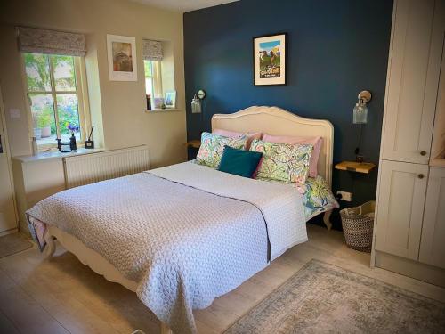 a bedroom with a bed with a white bedspread at The Garden Room at Warren House in Arncliffe